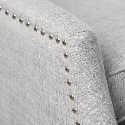 Fauteuil inclinable contemporain en tissu avec oreilles, système push-back et clous décoratifs
