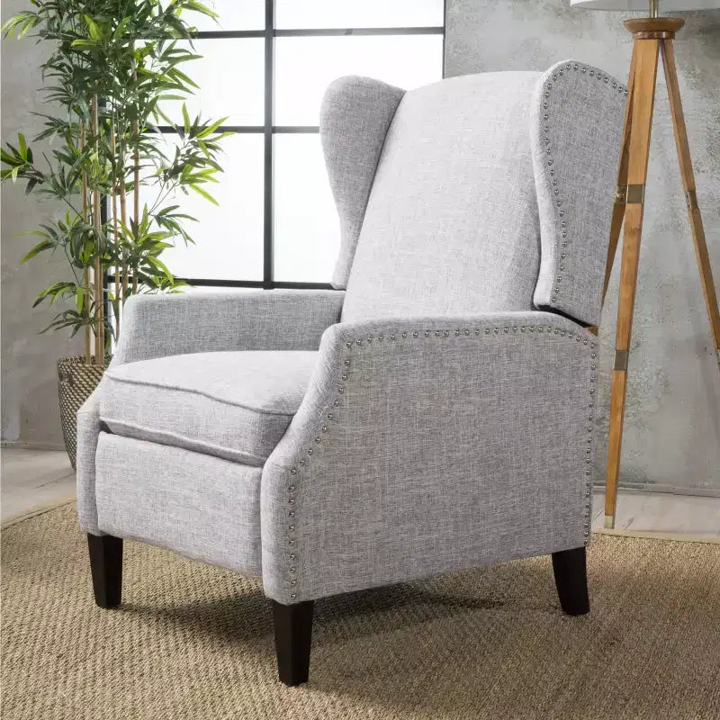 Fauteuil inclinable contemporain en tissu avec oreilles, système push-back et clous décoratifs